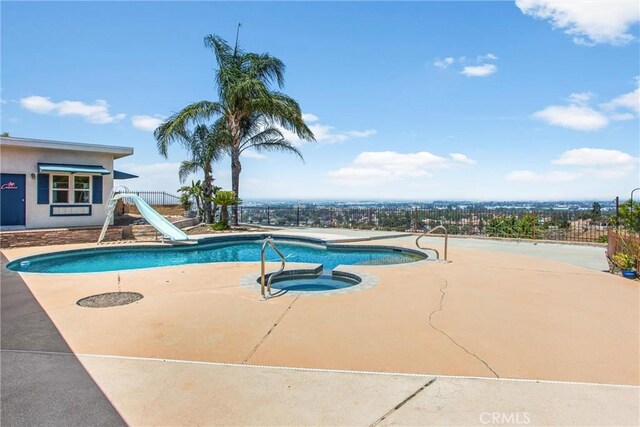 1835 Hilltop Dr, Colton, CA 92324 - view of swimming pool featuring a water slide, a patio area, and a pool with connected hot tub