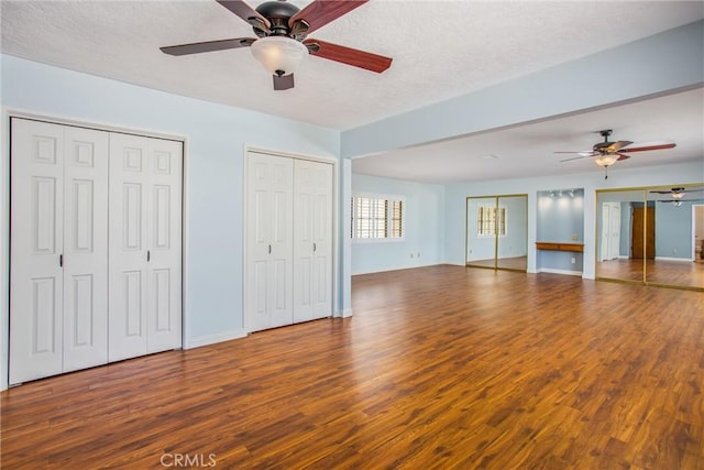 1835 Hilltop Dr, Colton, CA 92324 - unfurnished bedroom featuring wood finished floors, multiple closets, a textured ceiling, and ceiling fan