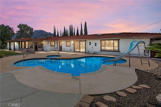 1835 Hilltop Dr, Colton, CA 92324 - outdoor pool with a water slide, an in-ground hot tub, and a patio