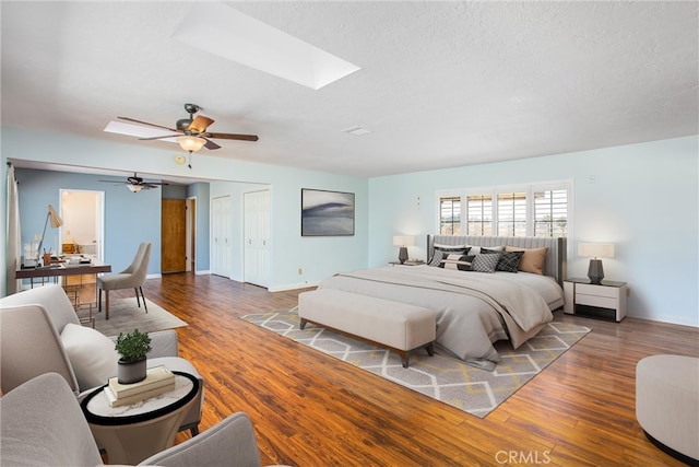 1835 Hilltop Dr, Colton, CA 92324 - bedroom featuring a skylight, wood finished floors, ceiling fan, and a textured ceiling