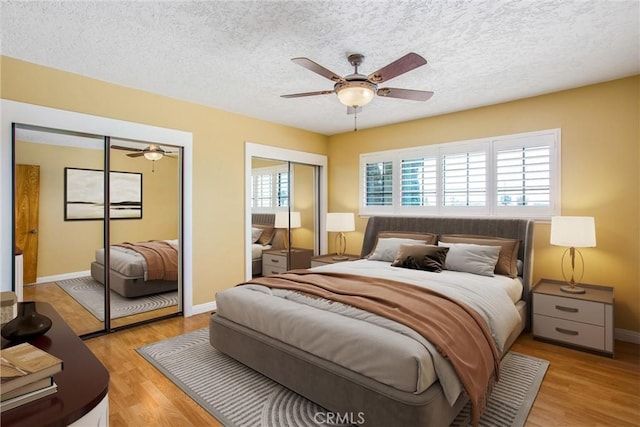 1835 Hilltop Dr, Colton, CA 92324 - bedroom featuring multiple closets, light wood-style flooring, a textured ceiling, and ceiling fan