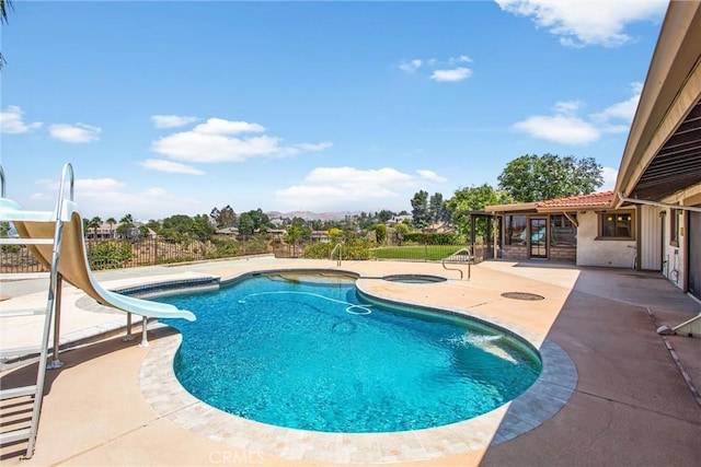 1835 Hilltop Dr, Colton, CA 92324 - view of swimming pool with a water slide, a patio area, and an in-ground hot tub