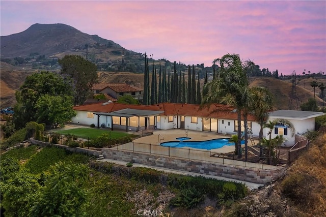1835 Hilltop Dr, Colton, CA 92324 - rear view of property with a patio area, a mountain view, and a tiled roof