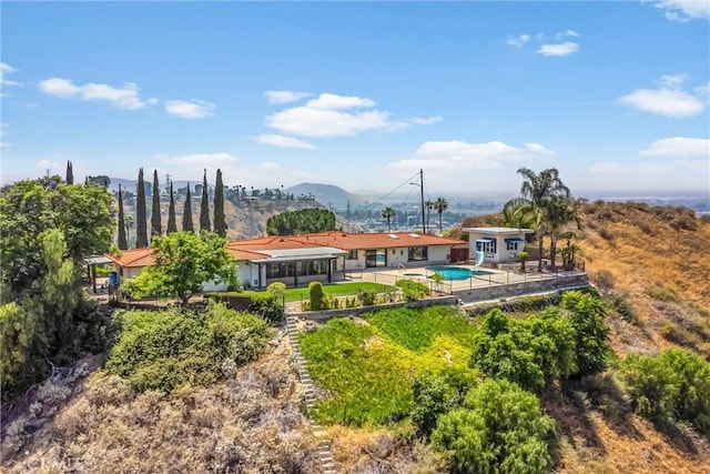 1835 Hilltop Dr, Colton, CA 92324 - back of house with an outdoor pool, a patio, and a mountain view