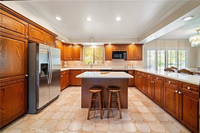 416 N Westridge Ave, Glendora, CA 91741 - kitchen with black appliances, a kitchen breakfast bar, light countertops, brown cabinetry, and ornamental molding