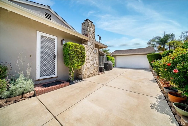 416 N Westridge Ave, Glendora, CA 91741 - view of side of property with stucco siding, a chimney, an outdoor structure, and a detached garage