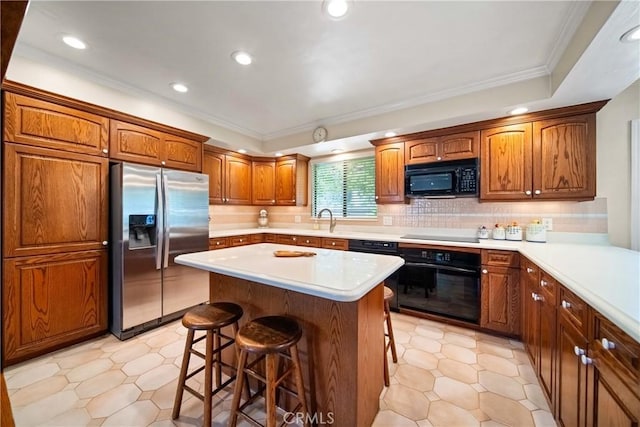 416 N Westridge Ave, Glendora, CA 91741 - kitchen with black appliances, a kitchen breakfast bar, light countertops, recessed lighting, and tasteful backsplash
