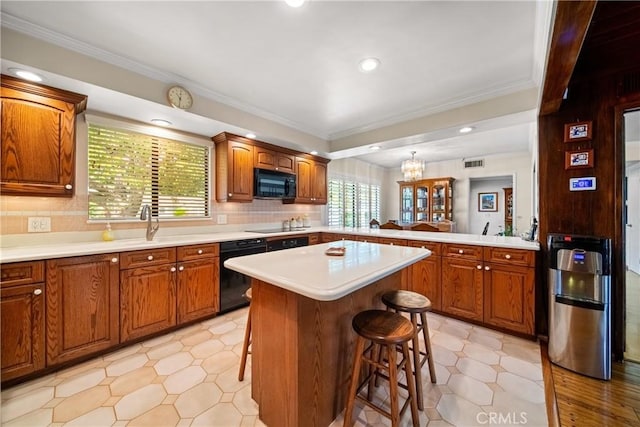 416 N Westridge Ave, Glendora, CA 91741 - kitchen with black appliances, a breakfast bar area, light countertops, brown cabinetry, and ornamental molding