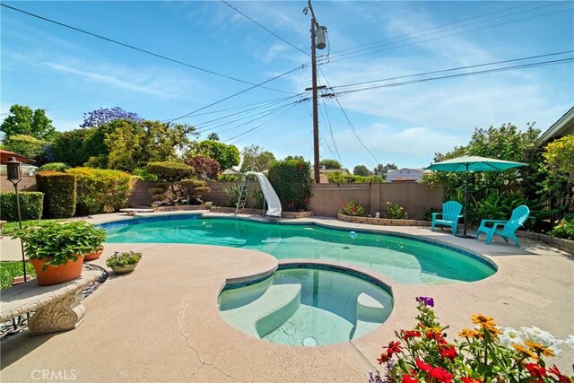 416 N Westridge Ave, Glendora, CA 91741 - view of swimming pool featuring a water slide, a fenced backyard, a patio area, and a pool with connected hot tub