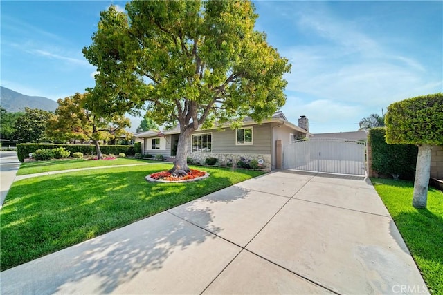 416 N Westridge Ave, Glendora, CA 91741 - ranch-style house with a gate, driveway, stone siding, a front yard, and a mountain view