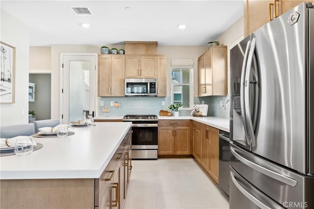 780 Stirrup, Rancho Mission Viejo, CA 92694 - kitchen featuring stainless steel appliances, backsplash, light countertops, light brown cabinetry, and recessed lighting