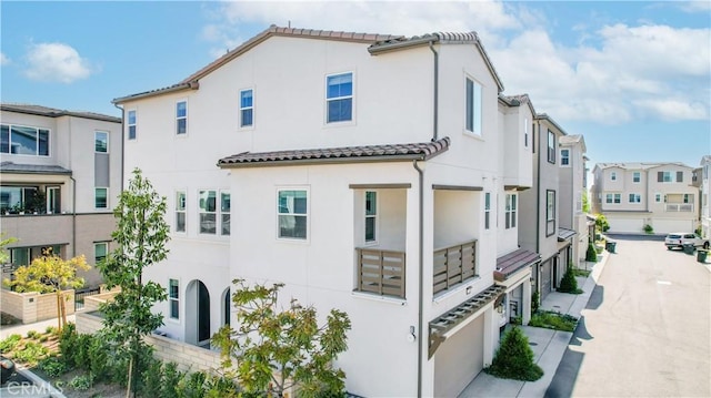 780 Stirrup, Rancho Mission Viejo, CA 92694 - view of property exterior with stucco siding, a tile roof, a garage, and a residential view