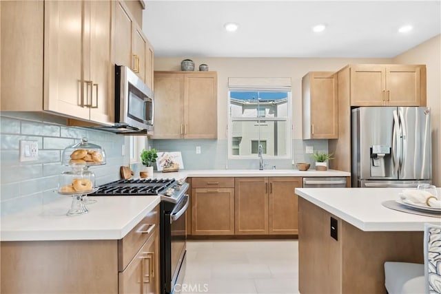 780 Stirrup, Rancho Mission Viejo, CA 92694 - kitchen with stainless steel appliances, light countertops, tasteful backsplash, light brown cabinetry, and recessed lighting
