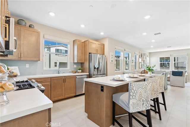 780 Stirrup, Rancho Mission Viejo, CA 92694 - kitchen featuring stainless steel appliances, a breakfast bar area, open floor plan, light countertops, and recessed lighting