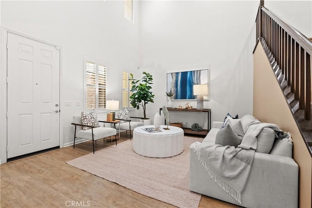152 Jaripol Cir, Rancho Mission Viejo, CA 92694 - living area featuring wood finished floors, a towering ceiling, and stairs