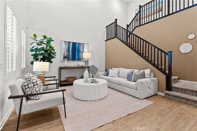 152 Jaripol Cir, Rancho Mission Viejo, CA 92694 - living room with a towering ceiling, stairway, wood finished floors, and healthy amount of natural light