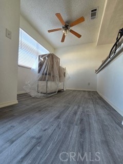 9633 Juniper Ave Unit F2, Fontana, CA 92335 - additional living space with a ceiling fan, wood finished floors, and a textured ceiling