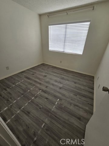 9633 Juniper Ave Unit F2, Fontana, CA 92335 - empty room featuring a textured ceiling and dark wood finished floors