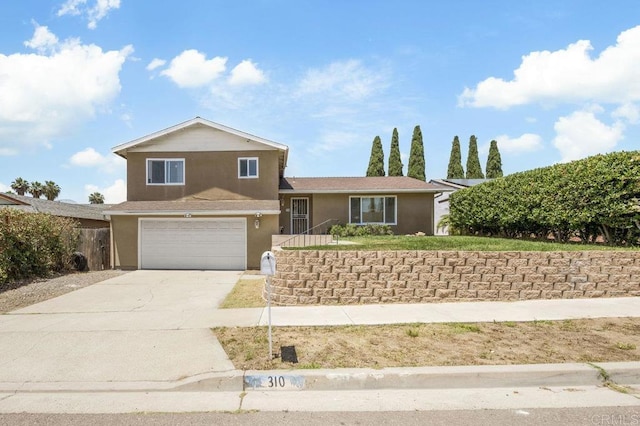 310 Michele Dr, Vista, CA 92084 - split level home with stucco siding, a garage, and driveway