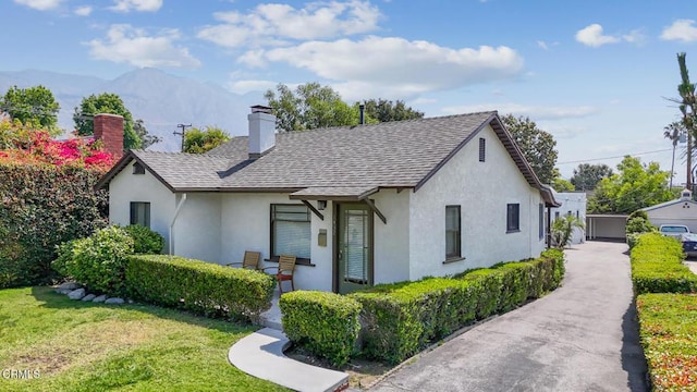 1430 Pepper Dr, Pasadena, CA 91104 - view of front of home featuring stucco siding, a chimney, a front lawn, a mountain view, and a shingled roof