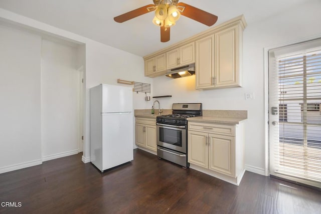 1430 Pepper Dr, Pasadena, CA 91104 - kitchen featuring freestanding refrigerator, cream cabinetry, gas range, under cabinet range hood, and light countertops