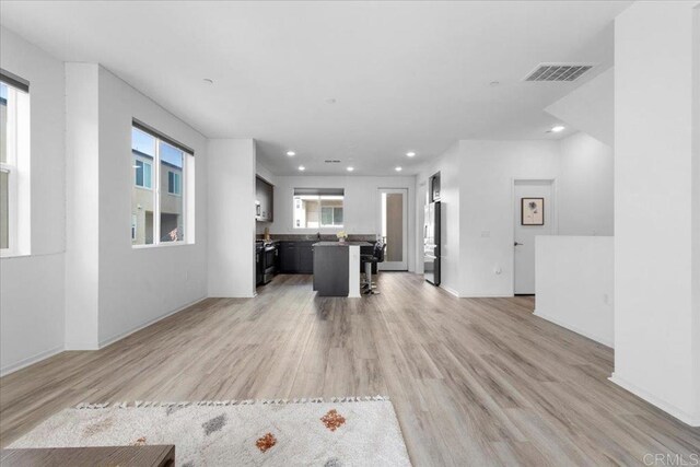 5265 Beachfront Cove St Unit 167, San Diego, CA 92154 - unfurnished living room featuring recessed lighting and light wood finished floors
