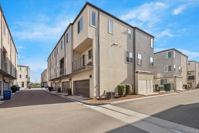 5265 Beachfront Cove St Unit 167, San Diego, CA 92154 - view of building exterior with a residential view and an attached garage