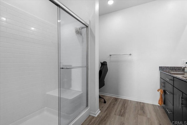 5265 Beachfront Cove St Unit 167, San Diego, CA 92154 - bathroom featuring a stall shower, wood finished floors, vanity, and recessed lighting