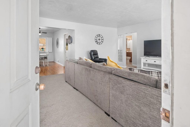 2842 E 18th St, National City, CA 91950 - carpeted living area featuring a ceiling fan and a textured ceiling