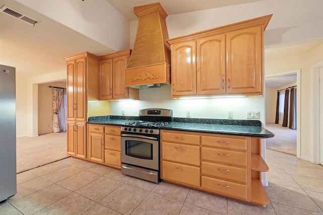 2814 Helix St, Spring Valley, CA 91977 - kitchen with stainless steel appliances, custom range hood, light colored carpet, dark countertops, and light tile patterned floors