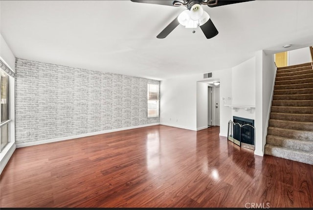 20821 E Calora St Unit E1, Covina, CA 91724 - unfurnished living room with stairs, ceiling fan, wood finished floors, and a fireplace