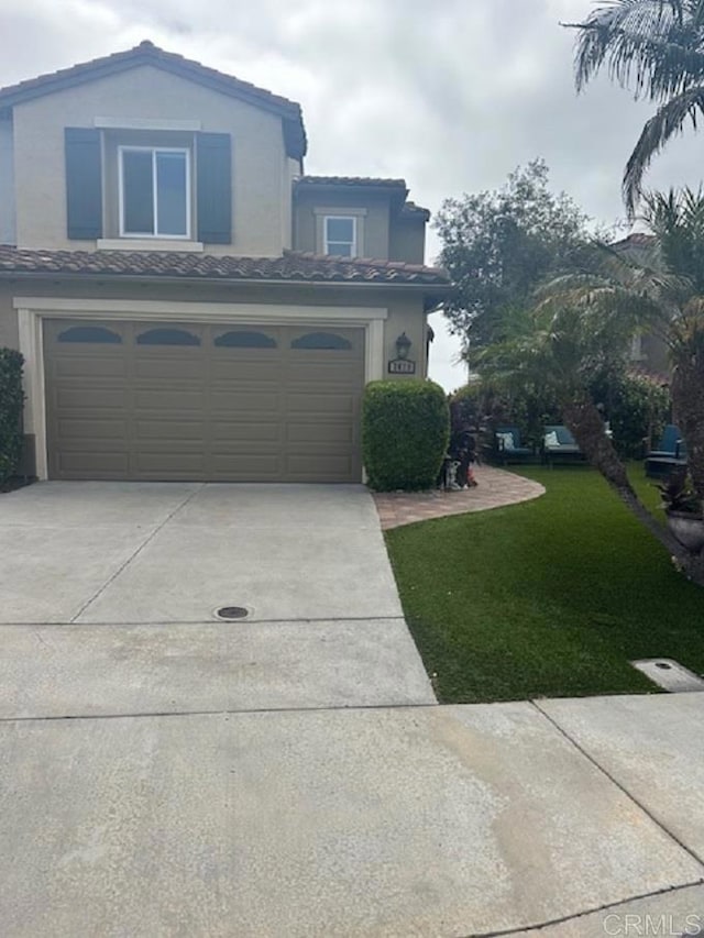 7479 Mermaid Ln, Carlsbad, CA 92011 - view of front of home with driveway, stucco siding, a tile roof, a garage, and a front yard