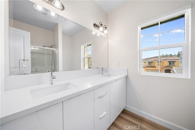 1379 Point Loma Pl, Walnut, CA 91789 - full bath featuring double vanity, wood finished floors, and an enclosed shower