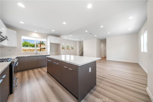 1379 Point Loma Pl, Walnut, CA 91789 - kitchen featuring modern cabinets, stainless steel range with gas cooktop, white cabinets, plenty of natural light, and recessed lighting
