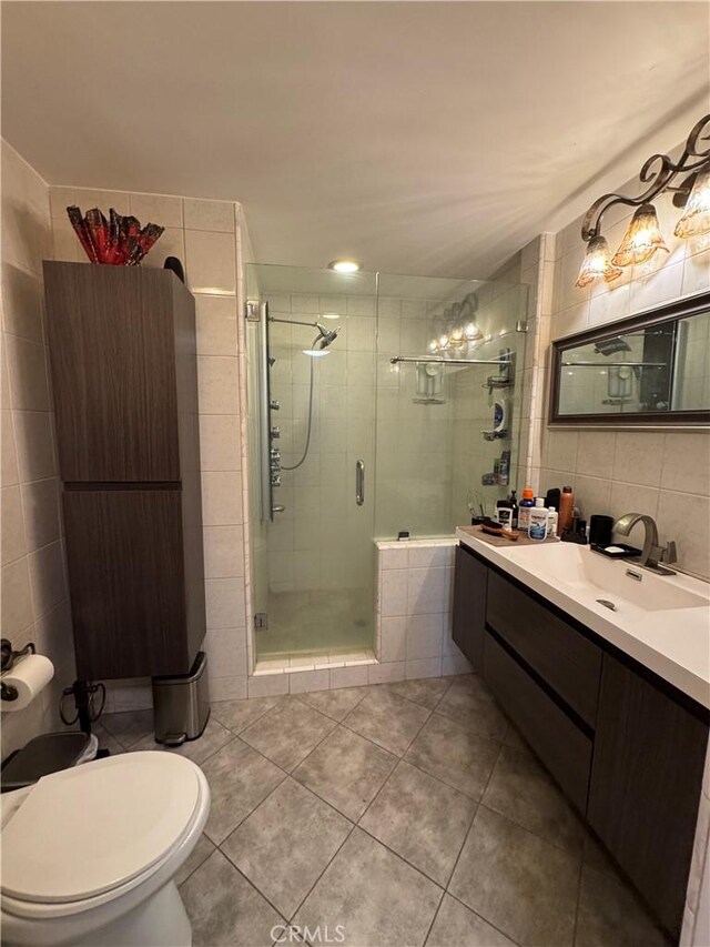 531 N Rossmore Ave Unit 202, Los Angeles, CA 90004 - bathroom featuring tile walls, tile patterned floors, radiator heating unit, a stall shower, and vanity