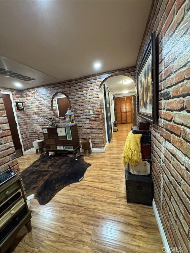 531 N Rossmore Ave Unit 202, Los Angeles, CA 90004 - hall with brick wall, arched walkways, and light wood-type flooring