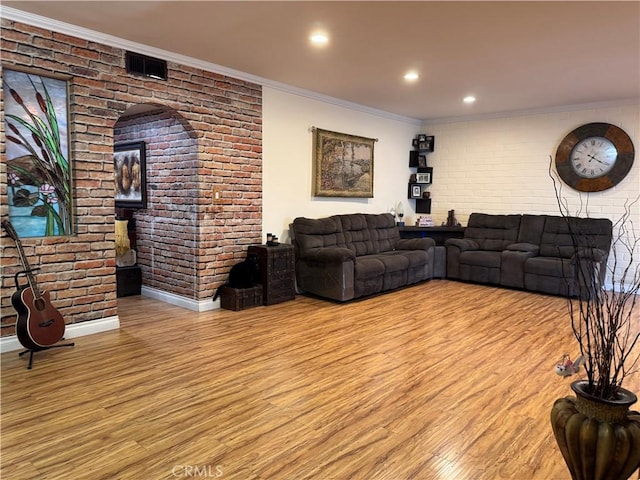 531 N Rossmore Ave Unit 202, Los Angeles, CA 90004 - living area featuring wood finished floors, brick wall, ornamental molding, arched walkways, and recessed lighting