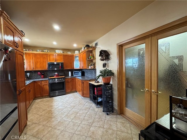531 N Rossmore Ave Unit 202, Los Angeles, CA 90004 - kitchen with stainless steel range, backsplash, open shelves, brown cabinets, and recessed lighting