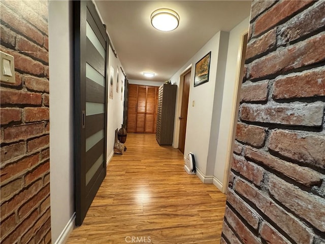 531 N Rossmore Ave Unit 202, Los Angeles, CA 90004 - hall with light wood-type flooring and brick wall