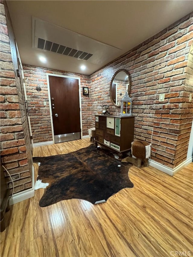 531 N Rossmore Ave Unit 202, Los Angeles, CA 90004 - entrance foyer with wood finished floors and brick wall