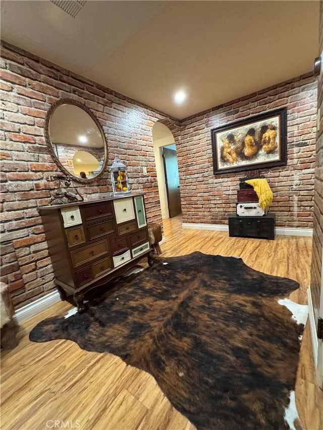 531 N Rossmore Ave Unit 202, Los Angeles, CA 90004 - interior space featuring brick wall, arched walkways, and wood finished floors
