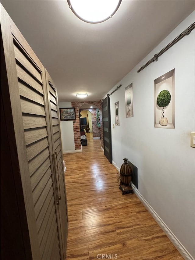 531 N Rossmore Ave Unit 202, Los Angeles, CA 90004 - hall featuring arched walkways and wood finished floors