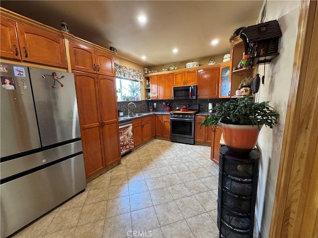 531 N Rossmore Ave Unit 202, Los Angeles, CA 90004 - kitchen featuring appliances with stainless steel finishes, open shelves, brown cabinets, backsplash, and dark countertops