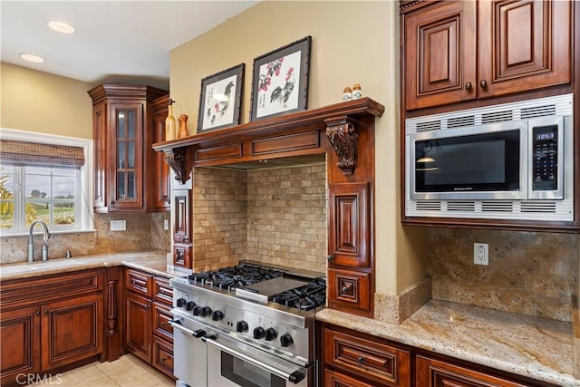 36090 Monte De Oro Rd, Temecula, CA 92592 - kitchen with stainless steel appliances, light stone countertops, decorative backsplash, glass insert cabinets, and light tile patterned floors