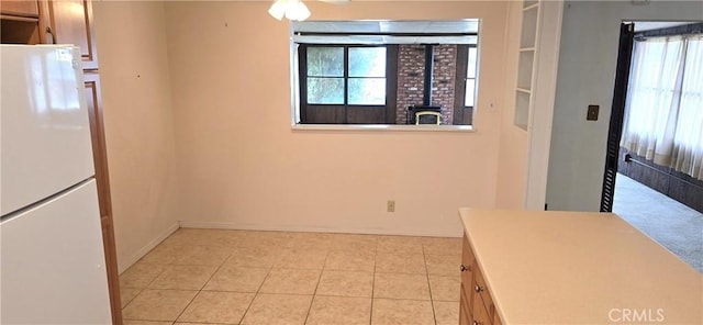 509 N 3rd St, Lompoc, CA 93436 - unfurnished dining area with a wood stove and light tile patterned floors