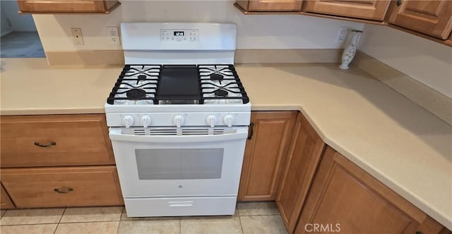 509 N 3rd St, Lompoc, CA 93436 - kitchen featuring white gas stove, brown cabinets, light countertops, and light tile patterned floors
