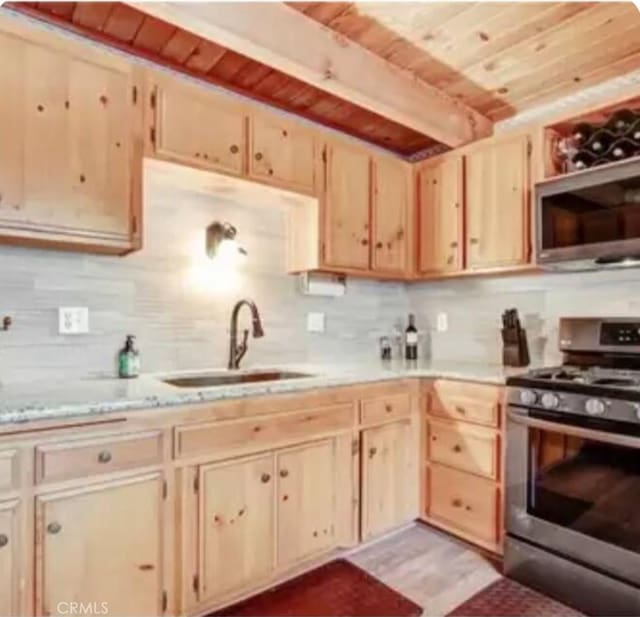 605 Kean Way, Big Bear City, CA 92314 - kitchen with stainless steel appliances, light brown cabinets, a wooden ceiling with exposed beams, light countertops, and tasteful backsplash