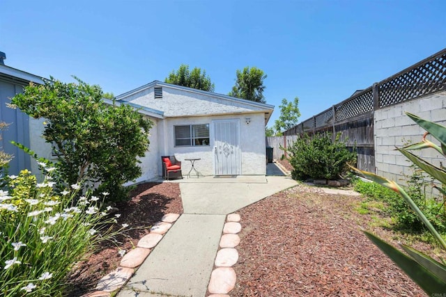 8802 Tyler St, Spring Valley, CA 91977 - rear view of property with a fenced backyard, stucco siding, and a patio