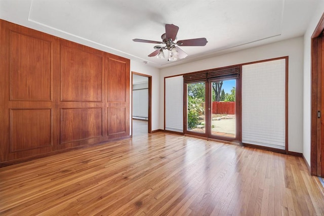 8802 Tyler St, Spring Valley, CA 91977 - unfurnished bedroom with access to outside, light wood-style floors, a baseboard heating unit, and a ceiling fan