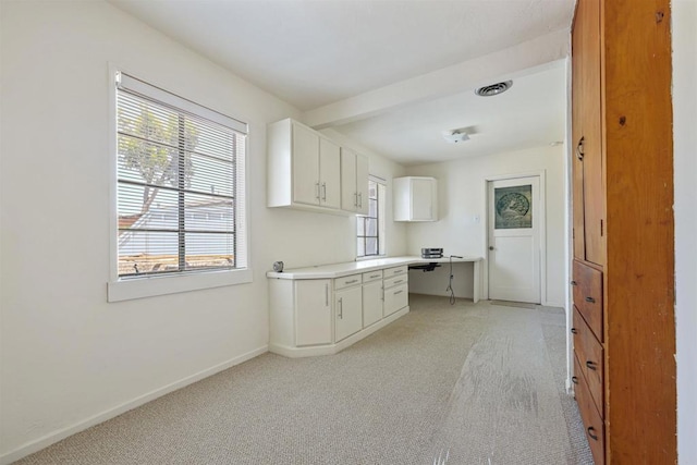 8802 Tyler St, Spring Valley, CA 91977 - kitchen with light colored carpet, white cabinets, and light countertops